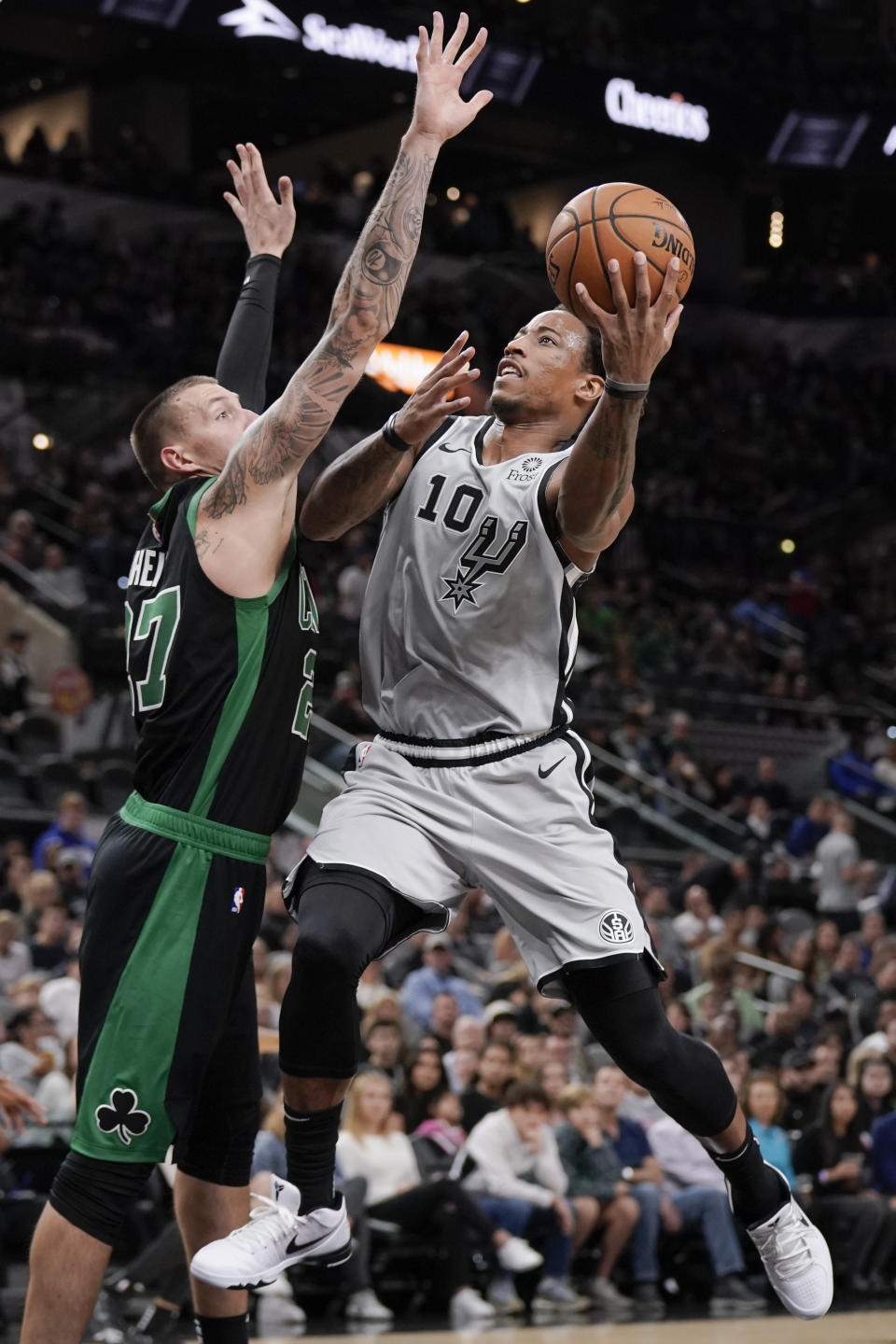 San Antonio Spurs' DeMar DeRozan (10) shoots against Boston Celtics' Daniel Theis during the first half of an NBA basketball game, Saturday, Nov. 9, 2019, in San Antonio. (AP Photo/Darren Abate)