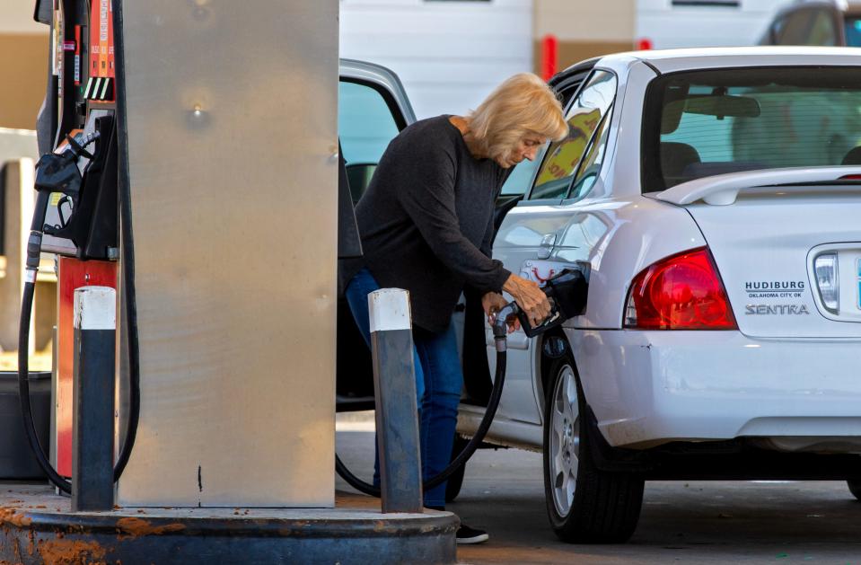 A customer gets gas on Friday at a station in Oklahoma City.