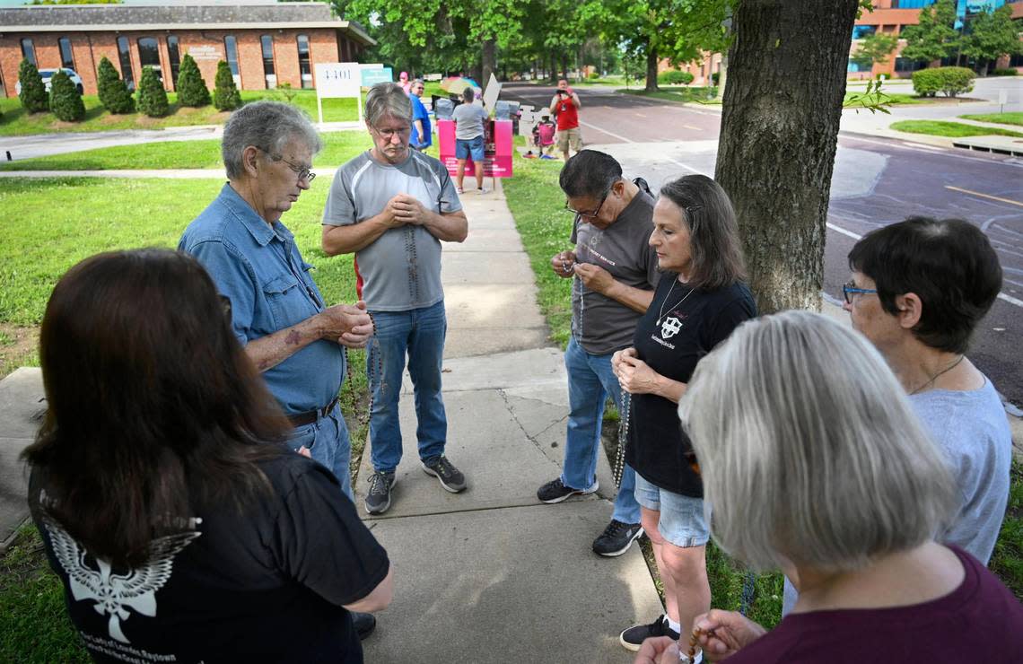 Holding their rosary beads, Prayer Warriors from St. John Francis Regis Catholic Church in Kansas City gathered outside of the Planned Parenthood and the Advice & Aid Pregnancy Centers in Overland Park in June to pray.