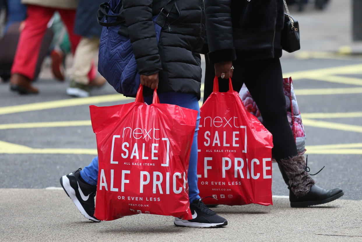 Shoppers with Next bags on Oxford Street, London, during the Boxing Day sales. (Photo: Isabel Infantes/PA Images via Getty Images)