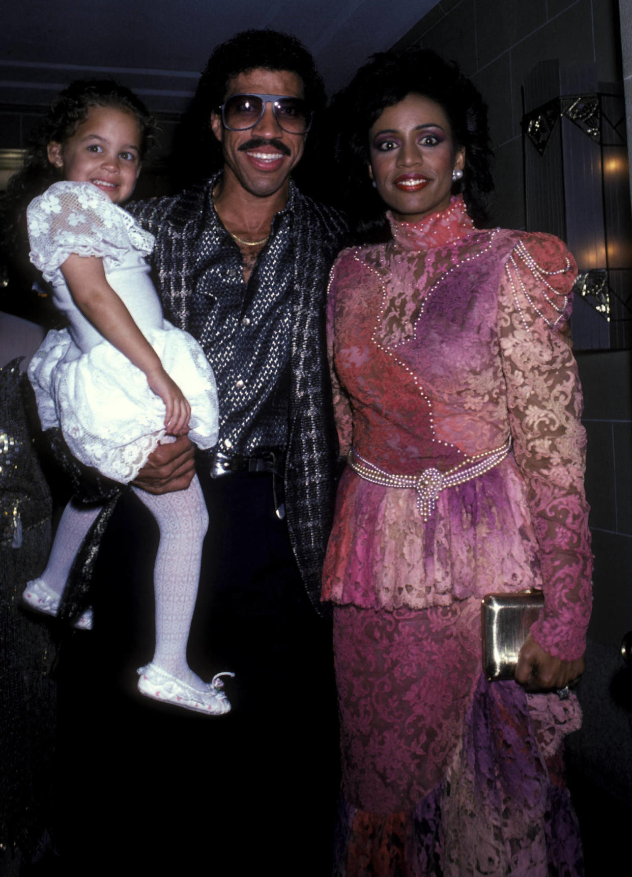 A young Nicole Richie with father Lionel Richie and mother Brenda Harvey Richie at a benefit concert in 1985. (Ron Galella, Ltd. / Ron Galella Collection via Getty Images)
