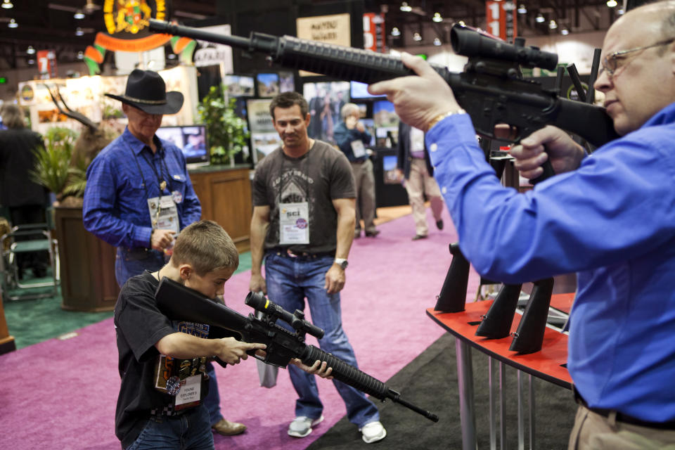 People test Trijicon rifle scopes at the Safari Club International Convention in Reno