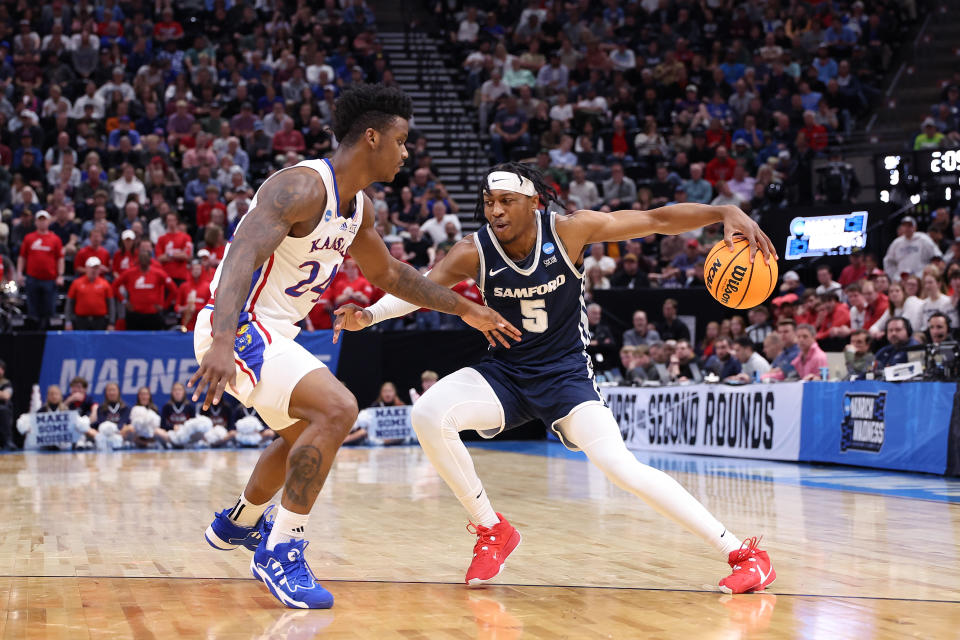 SALT LAKE CITY, UTAH - MARCH 21: A.J. Staton-McCray #5 of the Samford Bulldogs is defended by K.J. Adams Jr. #24 of the Kansas Jayhawks during the first half in the first round of the NCAA Men's Basketball Tournament at Delta Center on March 21, 2024 in Salt Lake City, Utah. (Photo by Christian Petersen/Getty Images)