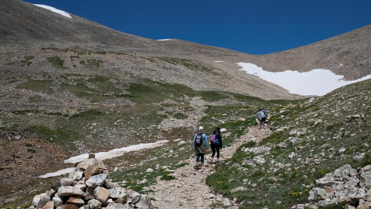  Hikers walk on the trail toward Mount Democrat near Alma. 