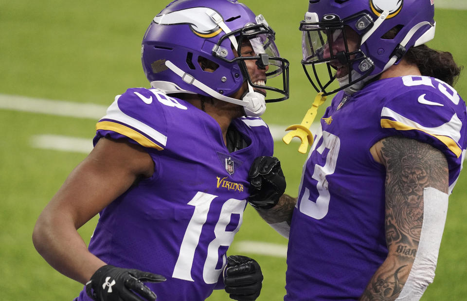 Minnesota Vikings wide receiver Justin Jefferson (18) celebrates with tight end Tyler Conklin (83) after he ran a pass from quarterback Kirk Cousins in for a touchdown in the first quarter of an NFL football game against the Carolina Panthers in Minneapolis, Sunday, Nov. 29, 2020. (Anthony Souffle/Star Tribune via AP)