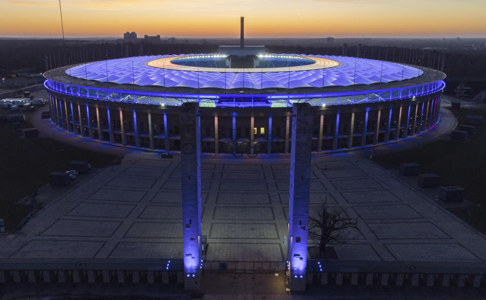 FILE - In this Feb. 21, 2021 file photo, the Olympic Stadium is illuminated as the sun sets after the German Bundesliga soccer match between Hertha BSC Berlin and RB Leipzig in Berlin, Germany. Scars of World War II and relics from its Nazi past are preserved at Berlin's Olympiastadion. When Spain plays England in the European Championship final, they will be playing in a stadium that doesn't hide it was built by the Nazis for the 1936 Olympic Games. (AP Photo/Michael Sohn, File)