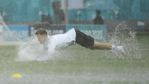 Austria's Christoph Baumgartner takes a dive on the pitch during a heavy rainfall before a training session at the National Arena stadium in Bucharest, Romania, Saturday, June 12, 2021, the day before their first match against North Macedonia. (AP Photo/Vadim Ghirda)