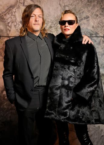 <p>Swan Gallet/WWD via Getty</p> Norman Reedus and Diane Kruger pose at the Saint Laurent Spring/Summer 2024 show