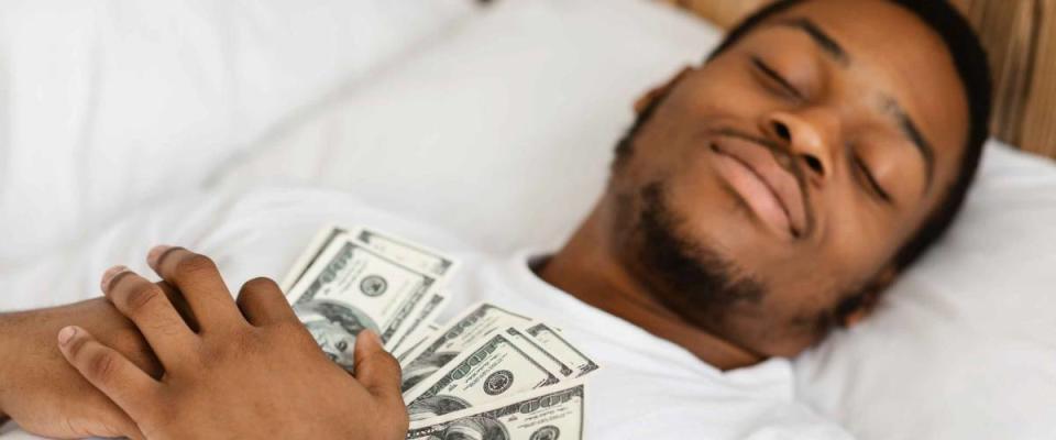 Sleeping man Holding Money Hugging Cash in bed