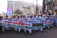 Supporters of several Islamist parties march in protest after Friday prayers in Dhaka, Bangladesh, Friday, Oct. 30, 2020. Thousands of Muslims and activists marched through streets and rallied across Bangladesh’s capital on Friday against the French president’s support of secular laws that deem caricatures of the Prophet Muhammad as protected under freedom of speech. (AP Photo/Mahmud Hossain Opu)