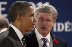 Stephen Harper talks to Barack Obama.