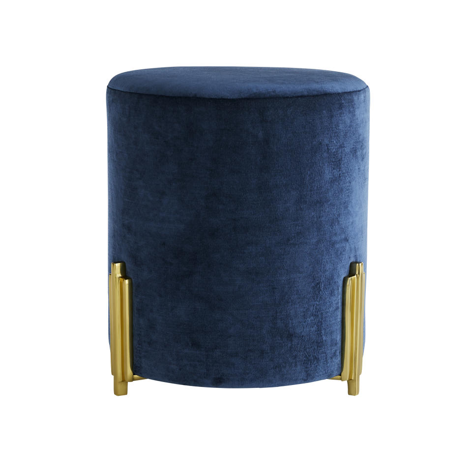 This undated photo shows Arteriors Warby ottoman. The Warby ottoman comes in a deep blue velvet with gold Deco-inspired accents and would add a chic touch of this inky hue to a living room, dressing room or master suite. (Arteriors via AP)