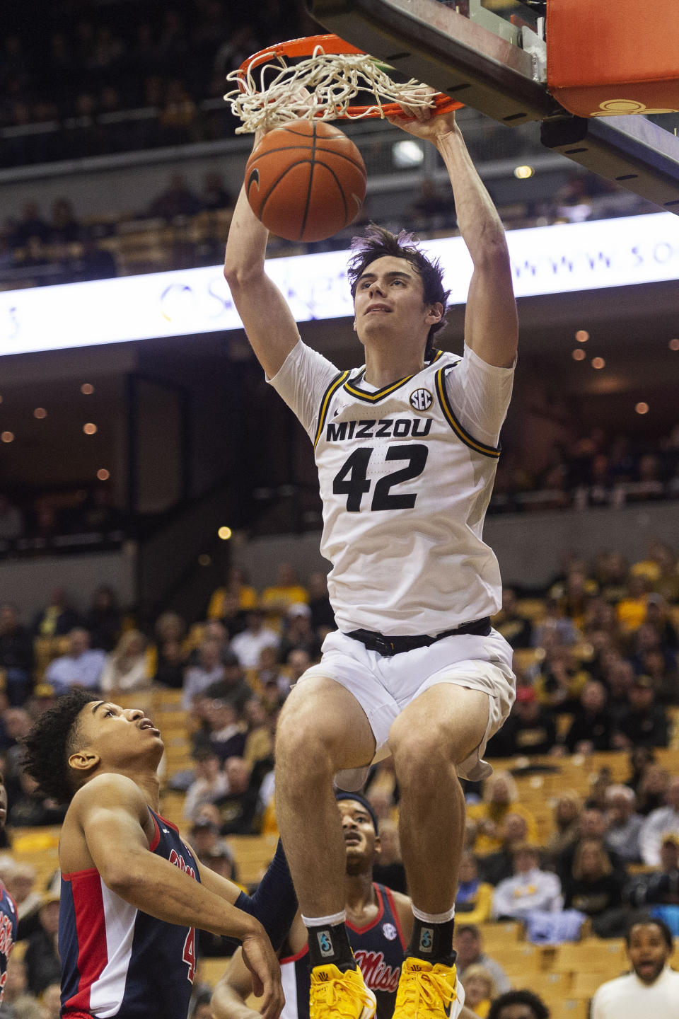 Missouri's Parker Braun, top, dunks the ball over Mississippi's Breein Tyree, left, during the second half of an NCAA college basketball game Tuesday, Feb. 18, 2020, in Columbia, Mo. Missouri won 71-68.(AP Photo/L.G. Patterson)