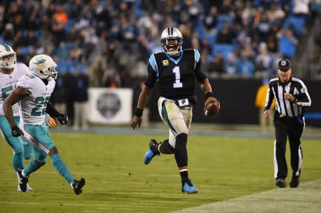 Nov 13, 2017; Charlotte, NC, USA; Carolina Panthers quarterback Cam Newton (1) runs as Miami Dolphins strong safety Nate Allen (29) defends in the third quarter at Bank of America Stadium. Bob Donnan-USA TODAY Sports