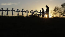 <p>Kenneth and Irene Hernandez pay their respects as they visit a makeshift memorial with crosses placed near the scene of a shooting at the First Baptist Church of Sutherland Springs, Monday, Nov. 6, 2017, in Sutherland Springs, Texas. (Photo: Eric Gay/AP) </p>