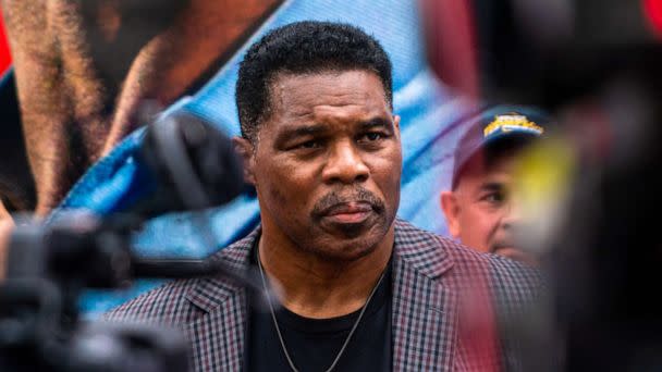 PHOTO: Herschel Walker speaks with the press following Herschel Walkers Unite Georgia Bus Stop rally at the Global Mall in Norcross, Ga, September 9, 2022. (Demetrius Freeman/The Washington Post via Getty Images, FILE)