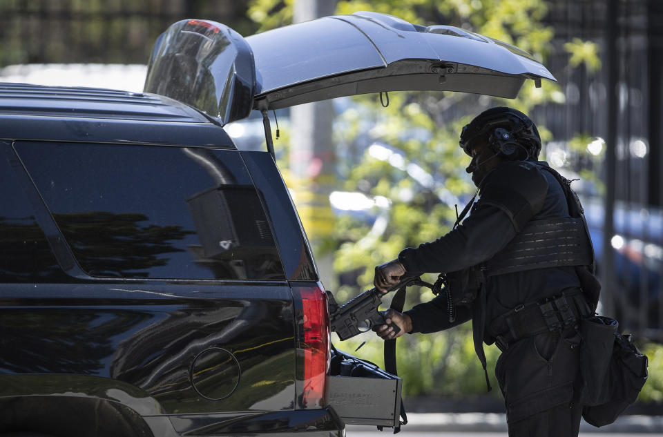 A Memphis Police officer stores his weapon after police diffused an active shooter situation near the University of Memphis Tuesday, May 2, 2023. (Patrick Lantrip/Daily Memphian via AP)