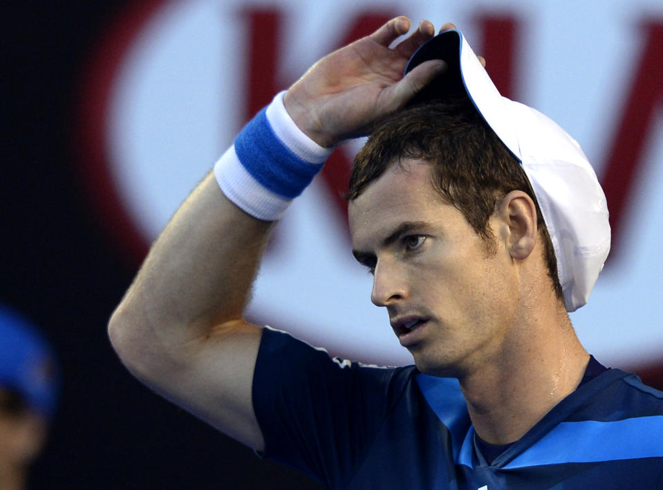 Andy Murray of Britain adjusts his cap as he plays Roger Federer of Switzerland during their quarterfinal at the Australian Open tennis championship in Melbourne, Australia, Wednesday, Jan. 22, 2014.(AP Photo/Andrew Brownbill)