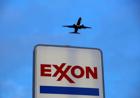 FILE PHOTO: An airplane comes in for a landing above an Exxon sign at a gas station in the Chicago suburb of Norridge, Illinois, U.S., October 27, 2016. REUTERS/Jim Young/File Photo