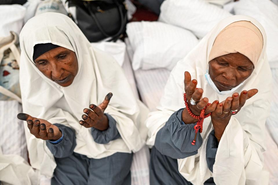 Muslim pilgrims pray upon their arrival in Mina, near Islam's holy city of Mecca on June 26, 2023, during the annual Hajj pilgrimage.