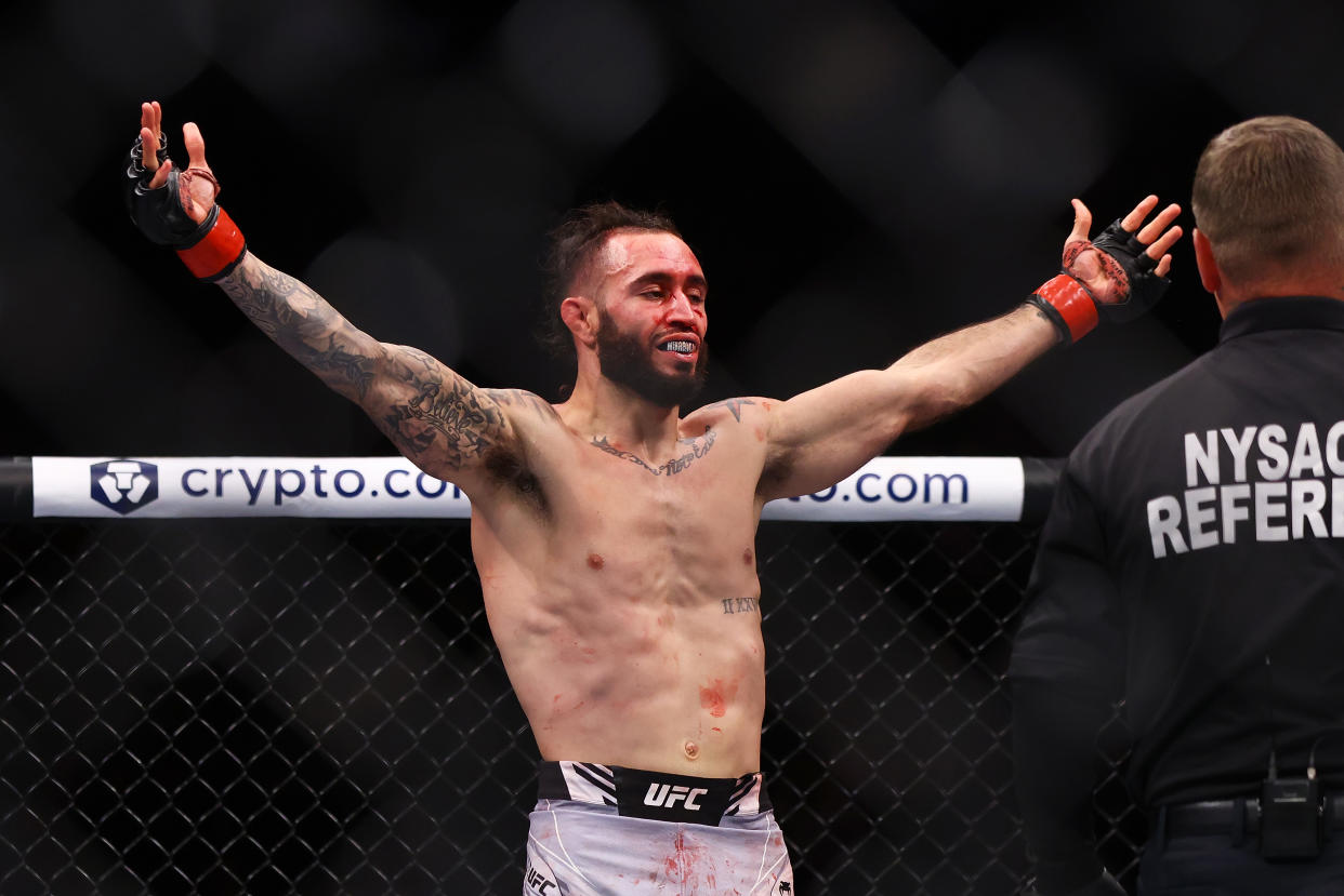 NEW YORK, NEW YORK - NOVEMBER 06:  Shane Burgos celebrates against Billy Quarantillo in their featherweight bout during the UFC 268 event at Madison Square Garden on November 06, 2021 in New York City. (Photo by Mike Stobe/Getty Images)
