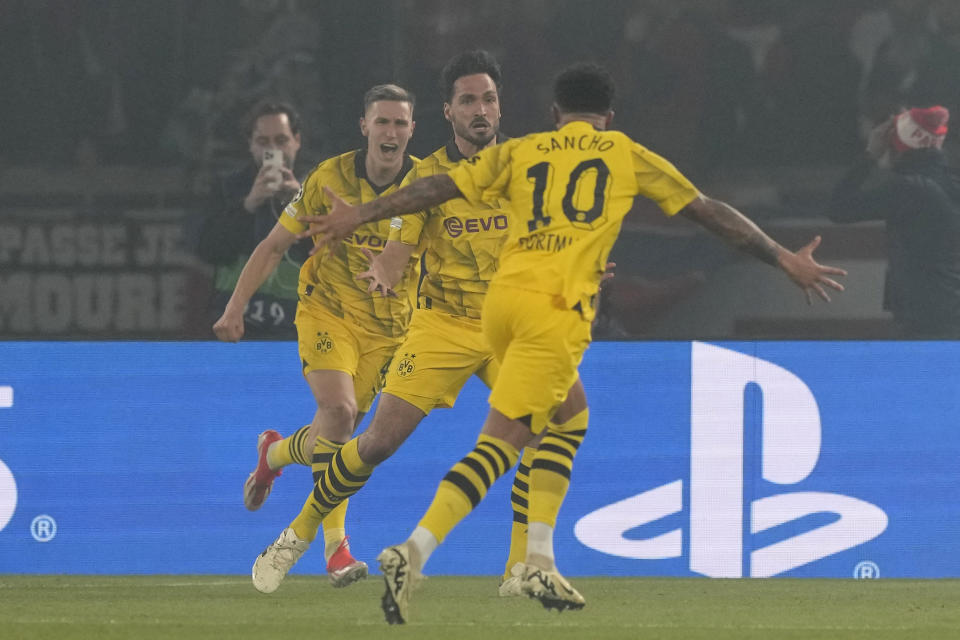 Dortmund's Mats Hummels, center, celebrates after scoring his side's opening goal during the Champions League semifinal second leg soccer match between Paris Saint-Germain and Borussia Dortmund at the Parc des Princes stadium in Paris, France, Tuesday, May 7, 2024. (AP Photo/Frank Augstein)