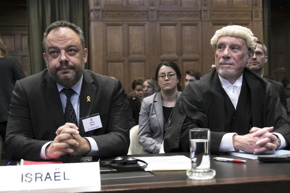 British jurist Malcolm Shaw, right, legal adviser to Israel's Foreign Ministry Tal Becker, left, look on during the opening of the hearings at the International Court of Justice in The Hague, Netherlands, Thursday, Jan. 11, 2024. The United Nations' top court opens hearings Thursday into South Africa's allegation that Israel's war with Hamas amounts to genocide against Palestinians, a claim that Israel strongly denies. (AP Photo/Patrick Post)