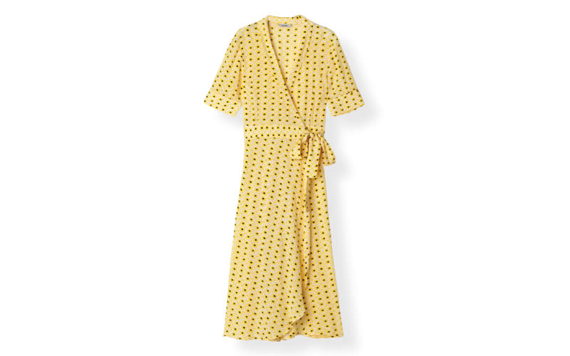 If you're a Ganni girl then we've found the perfect dress for you. Dress up with a basket bag and chunky clogs. <a href="https://www.ganni.com/en-gb/printed-crepe-wrap-dress-F3986.html?dwvar_F3986_color=Maize" rel="nofollow noopener" target="_blank" data-ylk="slk:Shop now;elm:context_link;itc:0;sec:content-canvas" class="link "><em>Shop now</em></a>.