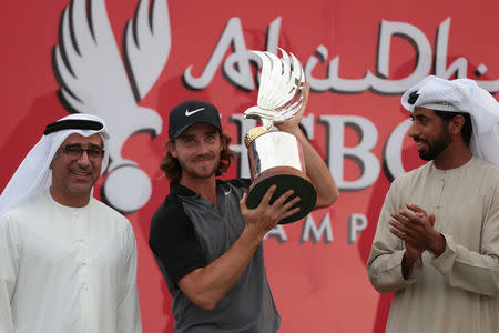 Golf - Abu Dhabi HSBC Golf Championship - Abu Dhabi, United Arab Emirates - 22/1/17 - Tommy Fleetwood of Britain holds up the trophy after winning. REUTERS/Stringer