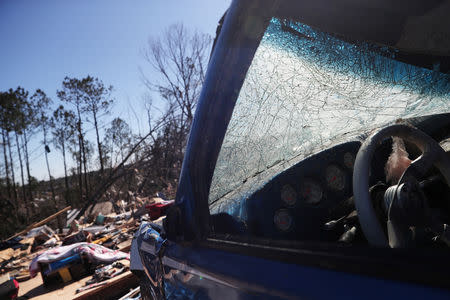 A house devastated is seen through shattered glass of a vehicle after two deadly back-to-back tornadoes, in Beauregard, Alabama, U.S., March 5, 2019. REUTERS/Shannon Stapleton