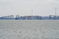 A container ship rests against the wreckage of the Francis Scott Key Bridge on Thursday, March 28, 2024, in Baltimore, Md. The ship rammed into the major bridge in Baltimore early Tuesday, causing it to collapse in a matter of seconds and creating a terrifying scene as several vehicles plunged into the chilly river below. (AP Photo/Matt Rourke)