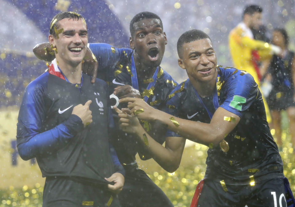 France’s Antoine Griezmann, points to two stars on his jersey indicating two world cup wins, as he celebrates with Paul Pogba and Kylian Mbappe