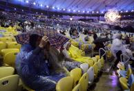 <p>Spectators wait in the rain for the start of the Summer Olympics closing ceremony inside Maracana stadium in Rio de Janeiro, Brazil, Sunday, Aug. 21, 2016. (AP Photo/Jae C. Hong) </p>