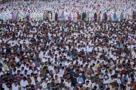 Muslims perform Eid al-Fitr prayers in the Tugu Pahlawan, Surabaya, East Java, Indonesia June 25, 2017 in this photo taken by Antara Foto. Antara Foto/Moch Asim/ via REUTERS