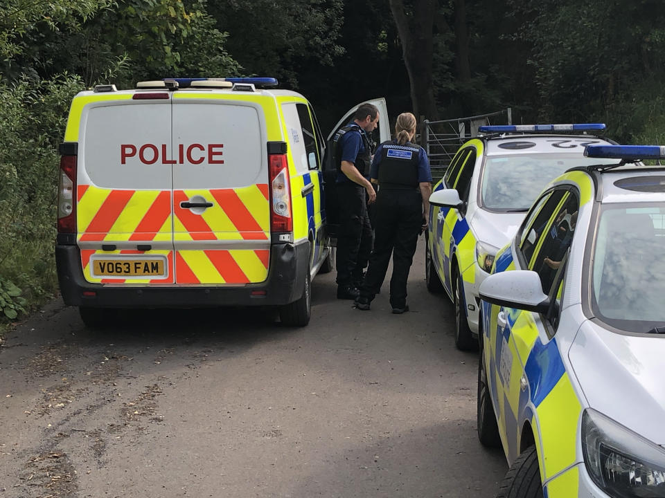 Police officers on a pass leading up to the summit of Brown Clee Hill in south Shropshire. A murder investigation has been launched after a pensioner was found dead in the countryside.