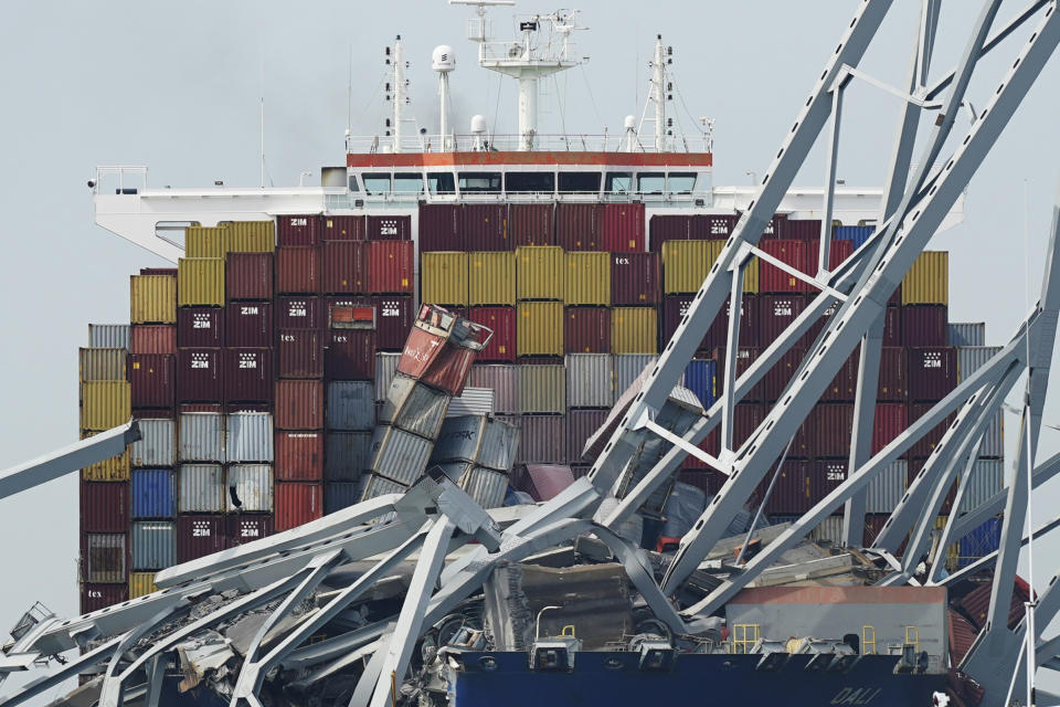 FILE - The container ship Dali is stuck under part of the Francis Scott Key Bridge after the ship hit the bridge, March 26, 2024, in Baltimore, Md. The FBI is conducting a criminal investigation into the deadly collapse of Baltimore’s Francis Scott Key Bridge that is focused on the circumstances leading up to it and whether all federal laws were followed. The FBI says Monday, April 15 it was present conducting court authorized law enforcement activity. (AP Photo/Steve Helber, File)