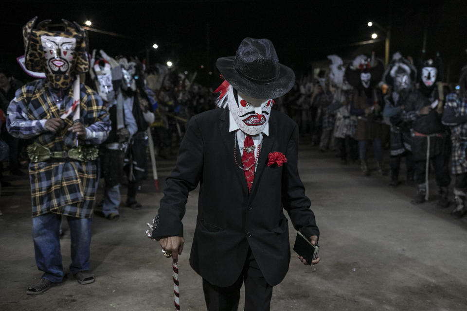 Villagers wearing costumes take part in a Holy Thursday local celebration in the town of Santa Rosalia, in the municipality of Mulege, Baja California Sur state, Thursday, April 6, 2023.(AP Photo/Emilio Espejel)