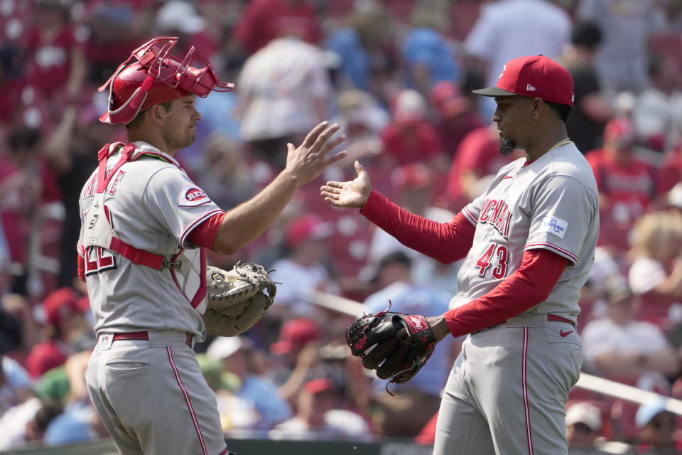 Cincinnati Reds catcher Luke Maile, left, and relief pitcher Alexis Diaz (43) celebrate an 8-4 victory over the St. Louis Cardinals following a baseball game Saturday, June 10, 2023, in St. Louis. (AP Photo/Jeff Roberson)