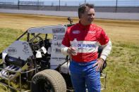 Jeff Gordon, a five-time winner of the Brickyard 400 and four-time NASCAR Cup Series champion, talks about driving a USAC midget car after taking some exhibition laps on the dirt track in the infield at Indianapolis Motor Speedway in Indianapolis, Thursday, June 17, 2021. (AP Photo/Michael Conroy)