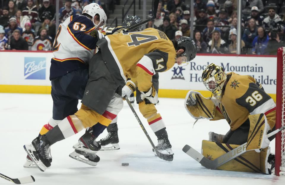 Colorado Avalanche left wing Artturi Lehkonen, left, is blocked from shooting the puck by Vegas Golden Knights defenseman Nicolas Hague, center, as Golden Knights goaltender Logan Thompson protects the net in the third period of an NHL hockey game Monday, Jan. 2, 2023, in Denver. (AP Photo/David Zalubowski)