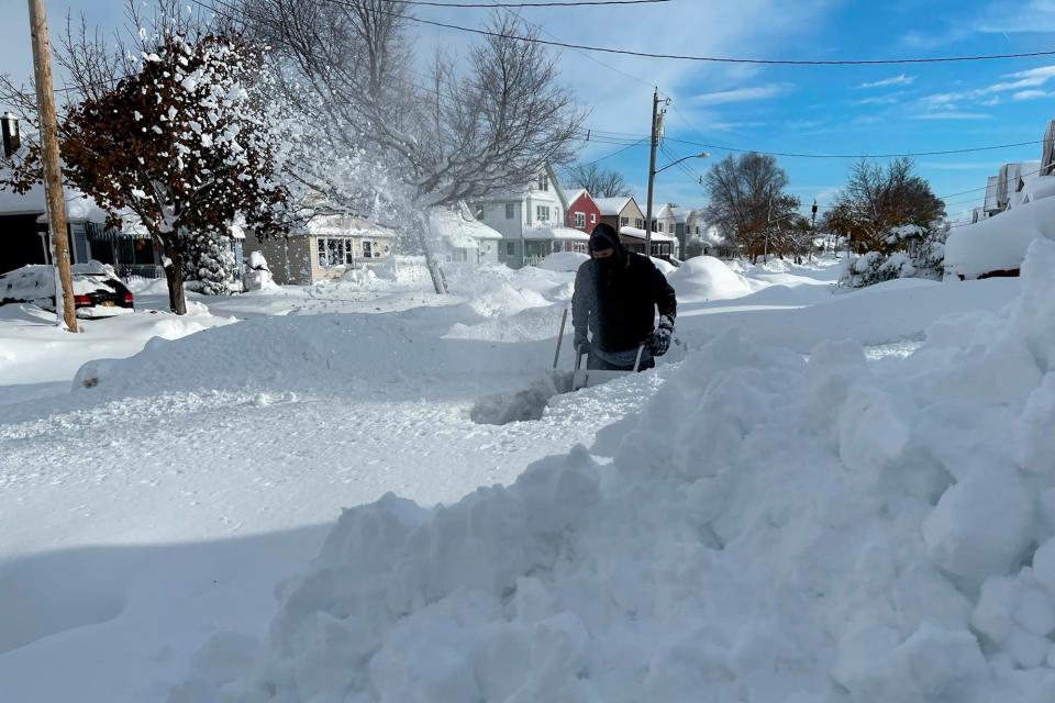 Martin Haslinger uses a snowblower outside his home in Buffalo, N.Y., on Saturday, Nov. 19, 2022 following a lake-effect snowstorm.