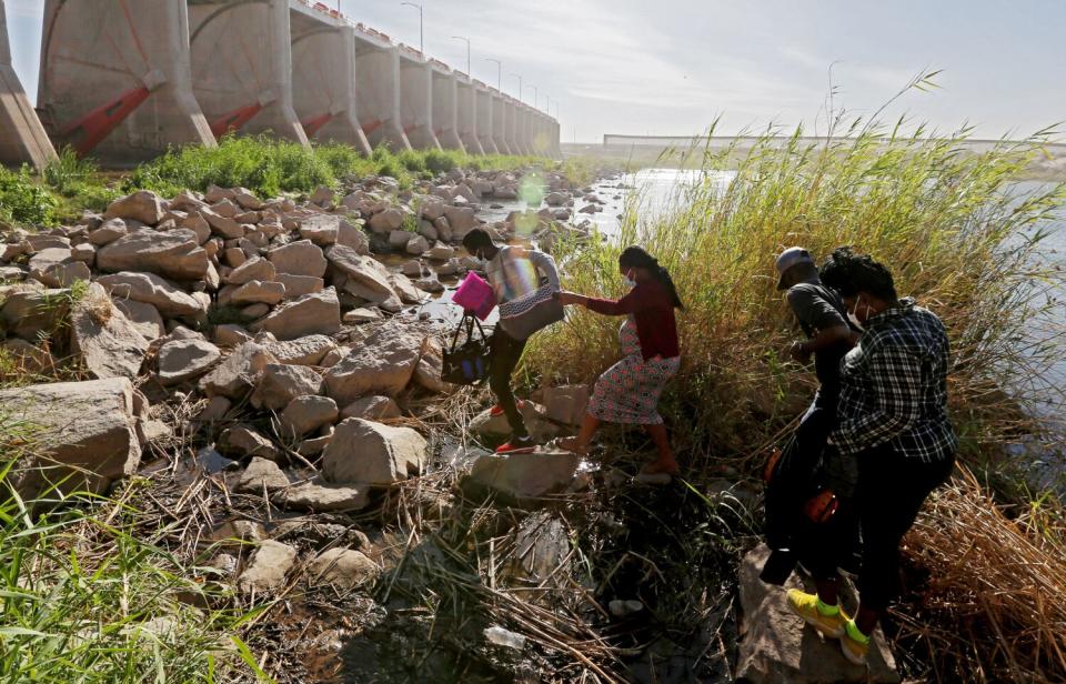 Haitian migrants cross the U.S.-Mexico border at the Morelos Dam in Los Algodones, Mexico.