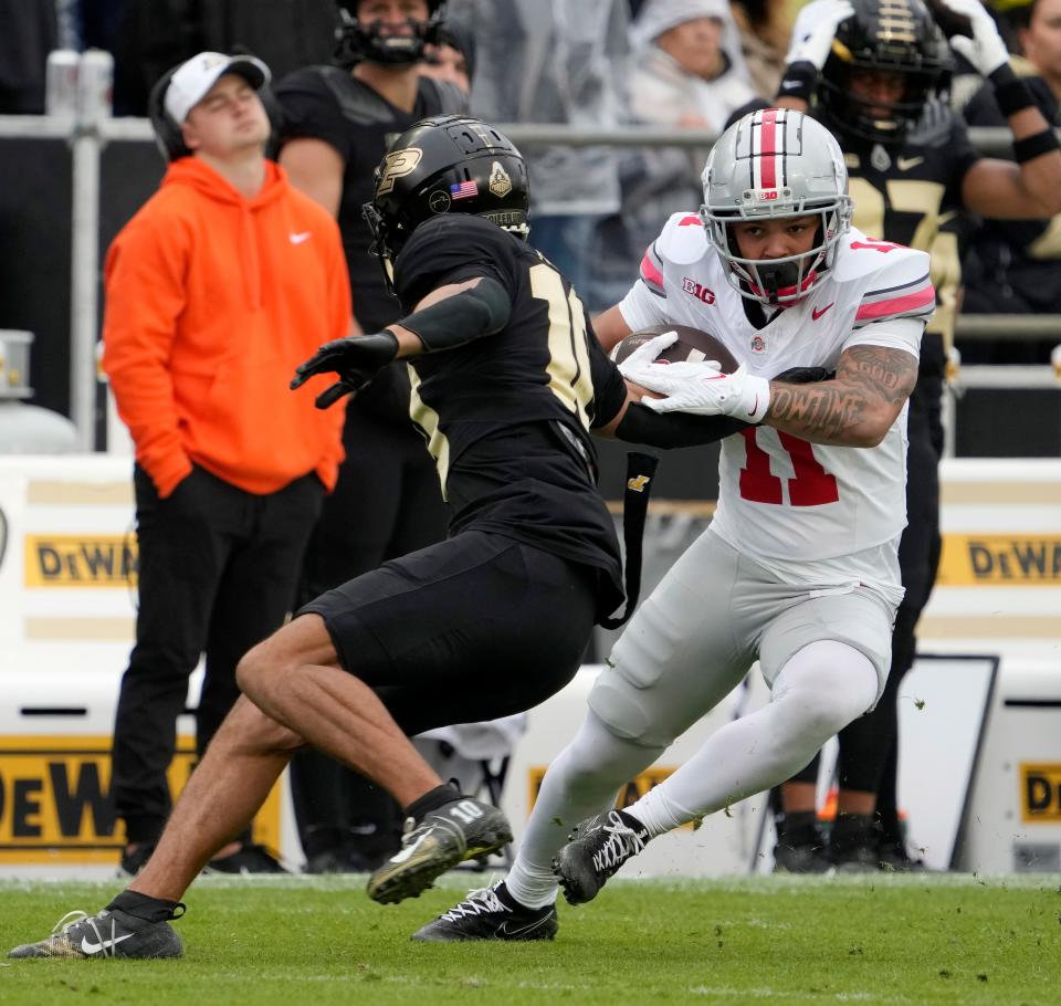 Oct. 14, 2023; Lafayette, In., USA; 
Ohio State Buckeyes wide receiver Brandon Inniss (11) is pursued by Purdue Boilermakers defensive back Cam Allen (10) during the second half of Saturday's NCAA Division I football game at Ross-Ade Stadium in Lafayette.