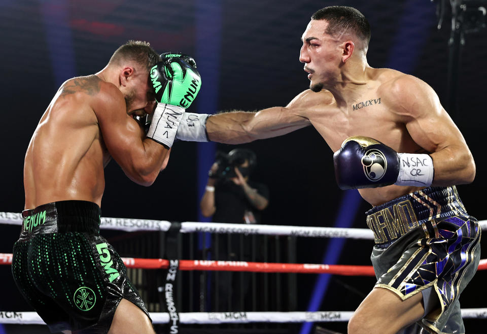 LAS VEGAS, NEVADA - OCTOBER 17: In this handout image provided by Top Rank, Teofimo Lopez Jr punches Vasiliy Lomachenko in their Lightweight World Title bout at MGM Grand Las Vegas Conference Center on October 17, 2020 in Las Vegas, Nevada. (Photo by Mikey Williams/Top Rank via Getty Images)