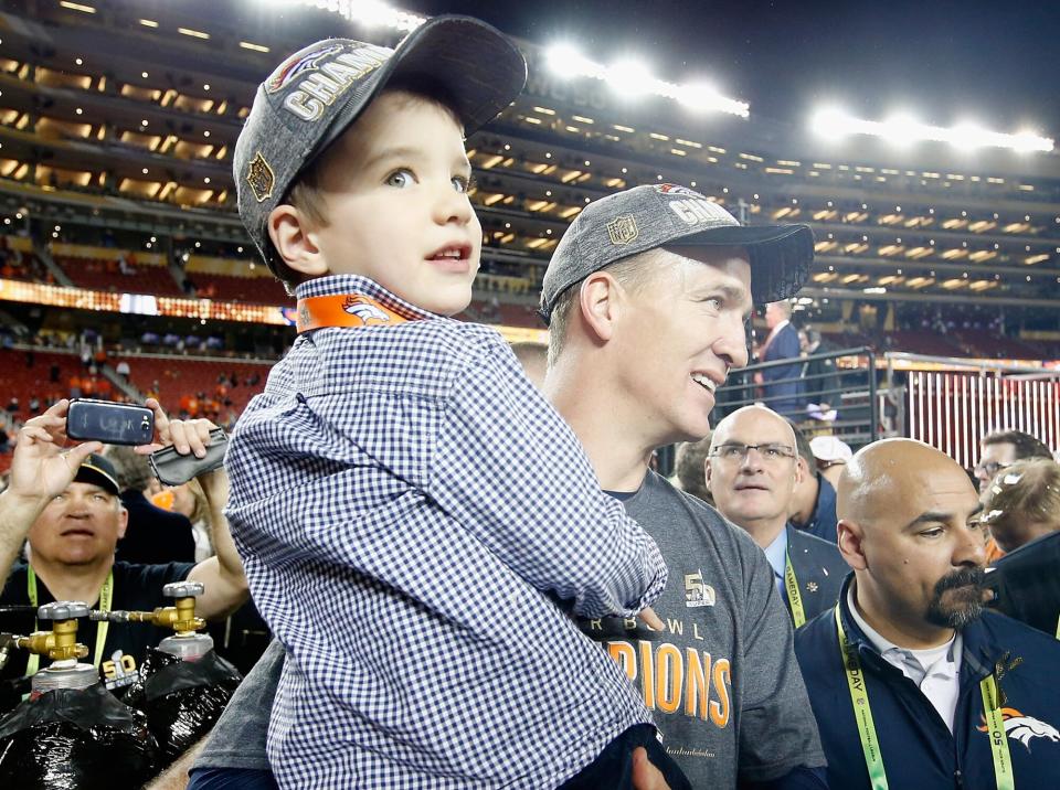 Peyton Manning #18 of the Denver Broncos holds his son Marshall after the Denver Broncos defeated the Carolina Panthers with a score of 24 to 10 to win Super Bowl 50 at Levi's Stadium on February 7, 2016 in Santa Clara, California