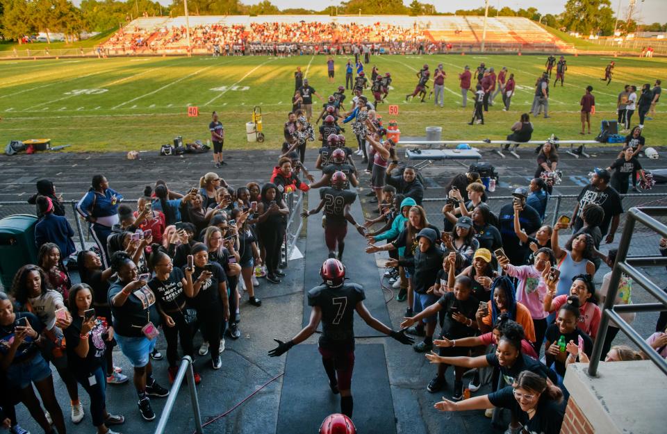 The Peoria High Lions take the field for their season-opening football game against Metamora on Friday, Aug. 26, 2022 at Peoria Stadium.