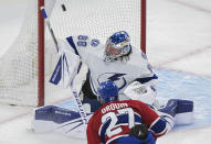 Montreal Canadiens' Jonathan Drouin (27) scores against Tampa Bay Lightning goaltender Andrei Vasilevskiy during the first period of an NHL hockey game Tuesday, March 21, 2023, in Montreal. (Graham Hughes/The Canadian Press via AP)