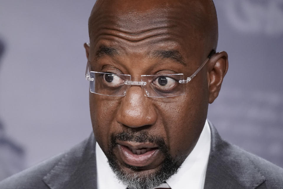 FILE - Sen. Raphael Warnock, D-Ga., joins Senate Majority Leader Chuck Schumer, D-N.Y., to speak to reporters after the Senate advanced a $280 billion bill designed to boost the U.S. semiconductor industry and to accelerate high tech research that backers say will be critical to the economy in future decades, at the Capitol in Washington, July 26, 2022. Warnock is running for his first full Senate term, pitching himself as a lawmaker willing to do whatever it takes to help his state. (AP Photo/J. Scott Applewhite, File)