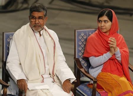 Nobel Peace Prize laureates Malala Yousafzai (R) and Kailash Satyarthi listen to speeches during the Nobel Peace Prize awards ceremony at the City Hall in Oslo December 10, 2014. REUTERS/Suzanne Plunkett