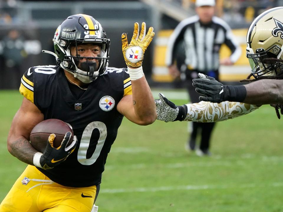 Jaylen Warren wards off a defender against the New Orleans Saints.